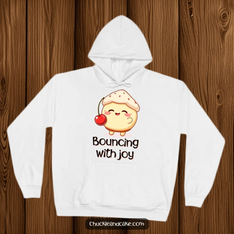 Funny hoodie featuring a giggling, plump muffin with rosy cheeks bouncing a cherry, offering warmth and sweet, humorous delight.