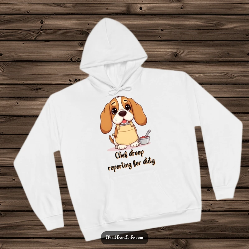 Funny Basset Hound hoodie, droopy-eared dog wearing a small apron, baking with a funny, concentrated look, perfect for cozy humor.