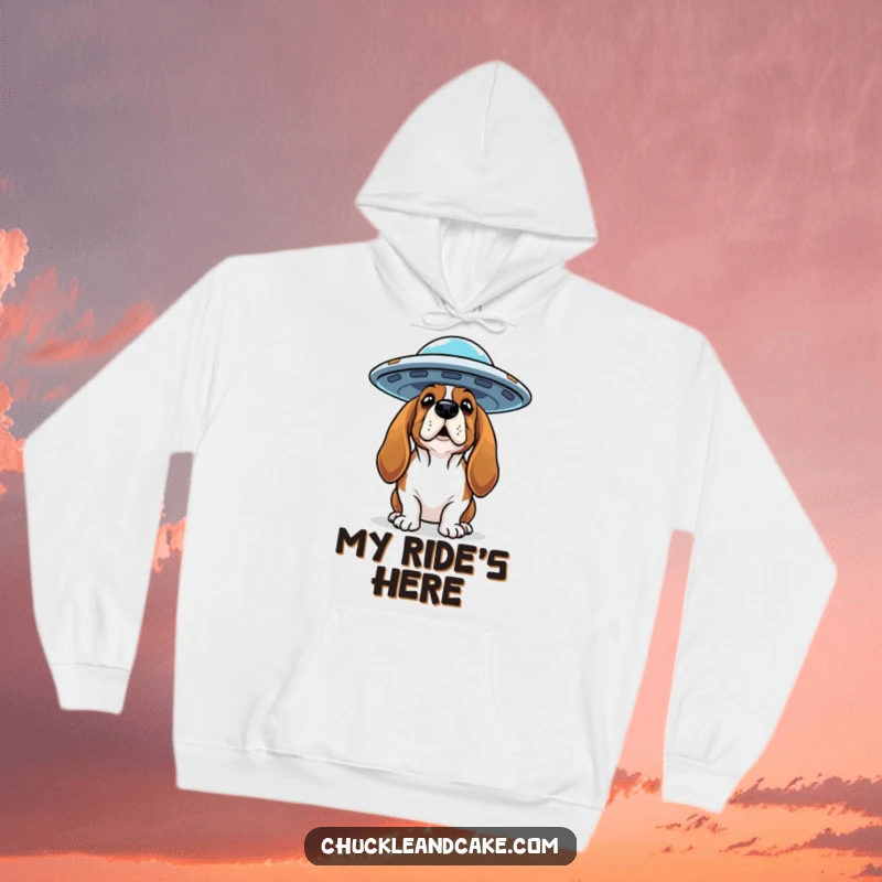 Funny Basset Hound hoodie featuring a curious dog looking up at a flying saucer, ideal for cozy cosmic comfort.