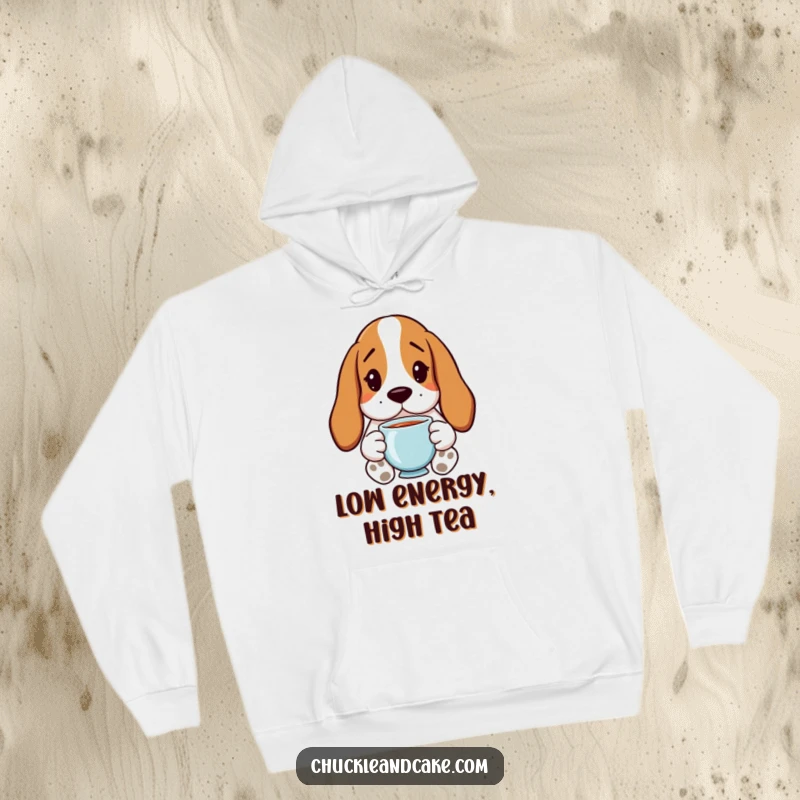 Funny Basset Hound Hoodie featuring droopy ears and holding tea, offering cozy humor for dog lovers.
