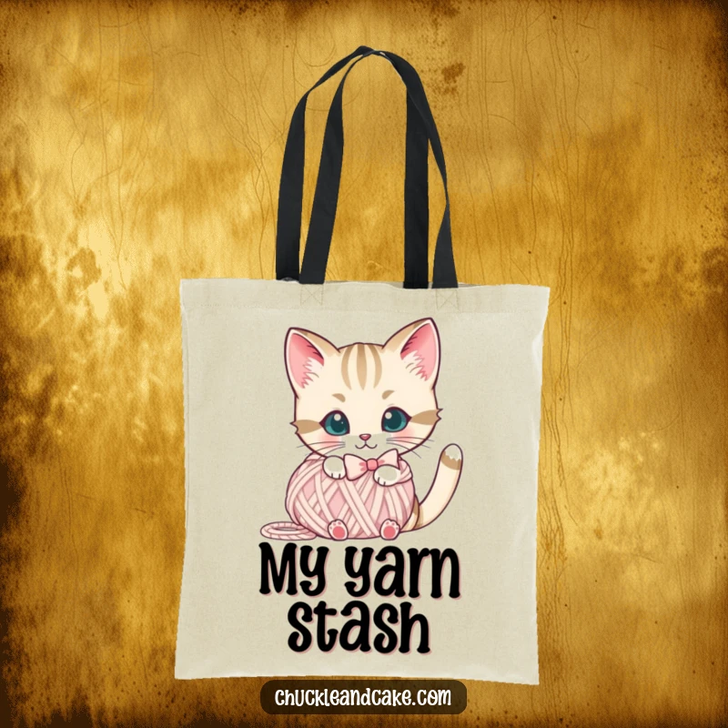 Funny Bobtail cat tote bag showing a cute cat with a bow peeking from behind a yarn ball, perfect for everyday use.